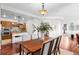 Open concept dining area with hardwood floors and a view into the kitchen at 2200 S University Blvd # 513, Denver, CO 80210