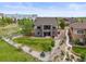 A beautiful backyard with green lawn and professional landscaping is on display in this home's exterior at 7367 S Tempe Ct, Aurora, CO 80016