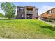 Spacious backyard with green lawn and two story home at 7367 S Tempe Ct, Aurora, CO 80016