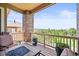 Enjoy outdoor living on this balcony, featuring a cozy fire pit and scenic views at 7367 S Tempe Ct, Aurora, CO 80016