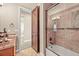 Bathroom with wood door and tile shower and tub at 7367 S Tempe Ct, Aurora, CO 80016