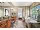 A serene bathroom retreat with dual vanities, a soaking tub, and natural light at 7367 S Tempe Ct, Aurora, CO 80016