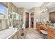 Spa-like bathroom featuring a soaking tub, walk-in shower, and dual vanities at 7367 S Tempe Ct, Aurora, CO 80016