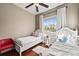 Charming bedroom featuring two beds, and a large window with neighborhood views at 7367 S Tempe Ct, Aurora, CO 80016