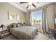 Cozy bedroom with large window offering pleasant views and patterned bedding at 7367 S Tempe Ct, Aurora, CO 80016