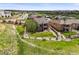 A two-story home with brick and siding has an manicured yard in a neighborhood at 7367 S Tempe Ct, Aurora, CO 80016