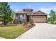 Charming home with attractive landscaping, stone accents, and a two-car garage at 7367 S Tempe Ct, Aurora, CO 80016