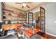 Elegant home office with built-in bookshelves and rich wood trim at 7367 S Tempe Ct, Aurora, CO 80016