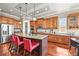 Beautiful kitchen island with granite countertops, wood cabinets, and stainless steel appliances at 7367 S Tempe Ct, Aurora, CO 80016