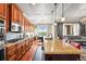 Open kitchen layout boasting granite counters, stainless appliances, and an eat-in bar at 7367 S Tempe Ct, Aurora, CO 80016
