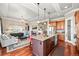 Open concept kitchen with island, granite countertops, modern appliances, and fireplace at 7367 S Tempe Ct, Aurora, CO 80016