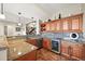 Inviting kitchen features granite counters, wine fridge, mosaic tile backsplash, and dark wood cabinetry at 7367 S Tempe Ct, Aurora, CO 80016
