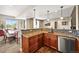 A stylish kitchenette with stainless steel appliances, granite countertops, and a dining area at 7367 S Tempe Ct, Aurora, CO 80016