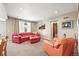 Spacious living room with plush seating, a large TV, and ample natural light at 7367 S Tempe Ct, Aurora, CO 80016