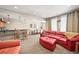 Open-concept living room with bar seating, a dining area, and comfortable furniture at 7367 S Tempe Ct, Aurora, CO 80016