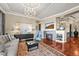 Cozy living room with a stone fireplace, stylish furnishings, and hardwood floors at 7367 S Tempe Ct, Aurora, CO 80016