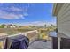 Back deck features a grill and seating area, with a green space in the distance at 47349 Lily Ave, Bennett, CO 80102
