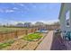 Fenced backyard with a splash pad and a grassy area, perfect for outdoor enjoyment at 47349 Lily Ave, Bennett, CO 80102