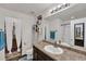 Well-lit bathroom featuring a vanity with a sink, toilet, shower, and walk in closet at 47349 Lily Ave, Bennett, CO 80102