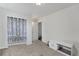 Bright bedroom features neutral paint and carpet, white trim, and a window bringing in natural light at 47349 Lily Ave, Bennett, CO 80102