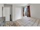 Cozy bedroom features a patterned rug, a bed with plaid covers, and a closet at 47349 Lily Ave, Bennett, CO 80102