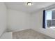 Empty bedroom featuring carpeted floors, a window with a curtain, and neutral walls at 47349 Lily Ave, Bennett, CO 80102