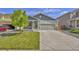 Charming two-story home with a well-maintained front yard and an attached two-car garage with a concrete driveway at 47349 Lily Ave, Bennett, CO 80102