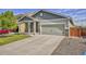 Charming two-story home with a covered porch, a two-car garage, and a well-maintained front yard at 47349 Lily Ave, Bennett, CO 80102