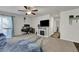 Open living room showcasing a fireplace, TV, desk area, and a comfortable seating area at 47349 Lily Ave, Bennett, CO 80102