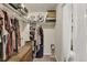 Walk-in closet with shelves, hanging storage, and a glimpse of a toilet at 47349 Lily Ave, Bennett, CO 80102