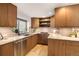 Modern kitchen featuring granite countertops and wood cabinetry at 1551 N Larimer St # 2504, Denver, CO 80202