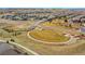 Wide aerial view showcases community layout with homes surrounding central park at 10770 Hillrose St, Parker, CO 80134