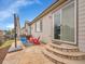 Back patio with stone pavers, comfortable seating, and an outdoor umbrella at 10770 Hillrose St, Parker, CO 80134