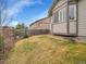 Well-maintained backyard featuring lush green grass and a charming gray home exterior at 10770 Hillrose St, Parker, CO 80134