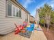 Backyard featuring a stone patio, seating, and a well-maintained lawn at 10770 Hillrose St, Parker, CO 80134