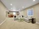 Open basement with a large sectional sofa and dining area at 10770 Hillrose St, Parker, CO 80134