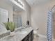 Well-lit bathroom with granite countertops, modern fixtures, and a shower at 10770 Hillrose St, Parker, CO 80134