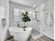 Beautiful bathroom with soaking tub, shower, white subway tiles, and natural light at 10770 Hillrose St, Parker, CO 80134