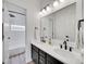 Elegant bathroom with double sinks, quartz countertop, and black accents at 10770 Hillrose St, Parker, CO 80134