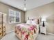 Cozy bedroom featuring floral bedding, natural light, and neutral décor at 10770 Hillrose St, Parker, CO 80134