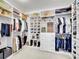 Organized walk-in closet with custom shelving, hanging racks, and drawers at 10770 Hillrose St, Parker, CO 80134