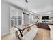 Bright dining area features a rustic wood table, fur benches, and large windows with plantation shutters at 10770 Hillrose St, Parker, CO 80134