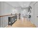 Light and airy hallway featuring hardwood floors, elegant decor, and neutral paint at 10770 Hillrose St, Parker, CO 80134