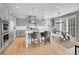 Modern kitchen with stainless steel appliances, an island with seating, and stylish gray cabinetry at 10770 Hillrose St, Parker, CO 80134