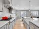Galley kitchen features stainless steel appliances, gray cabinets, white countertops, and hardwood floors at 10770 Hillrose St, Parker, CO 80134