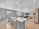 Open floor plan showcasing a kitchen island with white countertops, dining area, and a cozy living room at 10770 Hillrose St, Parker, CO 80134