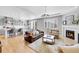 Cozy living room with a fireplace, hardwood floors, and open concept design at 10770 Hillrose St, Parker, CO 80134