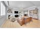 Bright living room with a fireplace, hardwood floors, and comfortable seating at 10770 Hillrose St, Parker, CO 80134