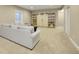 Spacious living room featuring plush carpeting and custom built-in storage at 10770 Hillrose St, Parker, CO 80134