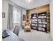 Comfortable office with natural light, wood accent wall, and built-in bookshelves at 10770 Hillrose St, Parker, CO 80134